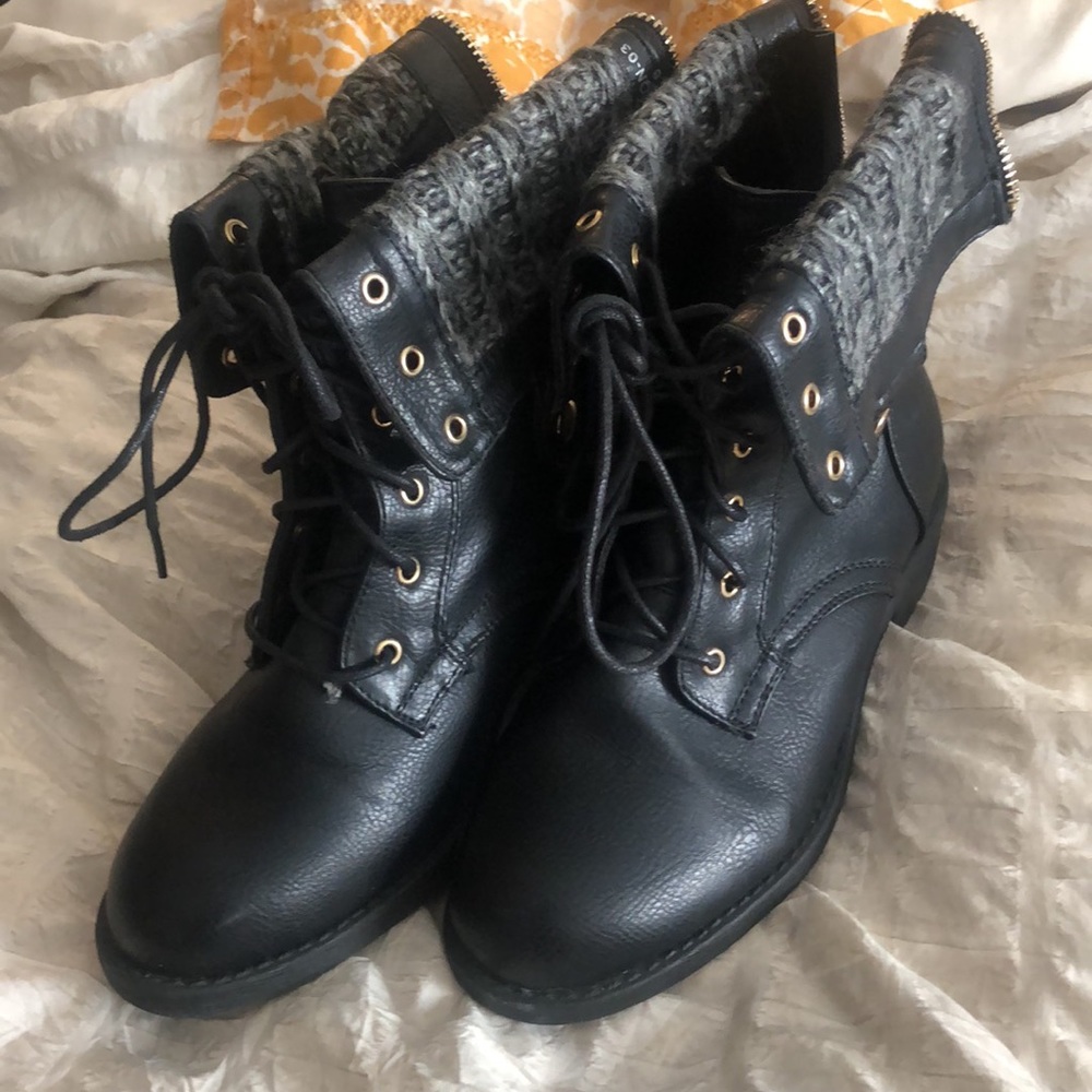 Black boots with gold accents and a grey finish
